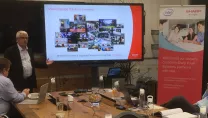 People in a meeting using a Sharp interactive display