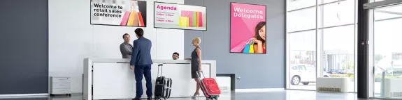 A man and woman with luggage at a check in desk